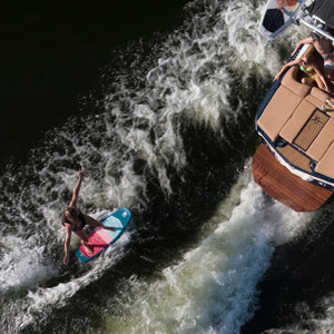 Wake surfer cruising behind boat